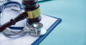 gavel and stethoscope on clipboard